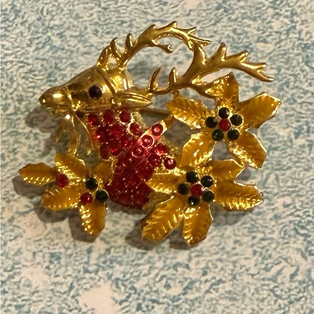 Elegant Gold Tone Reindeer Brooch with Red Accents